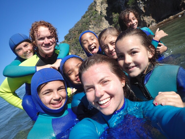 Selfie of kids in wetsuits.