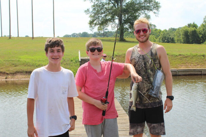 Boys holding fish.