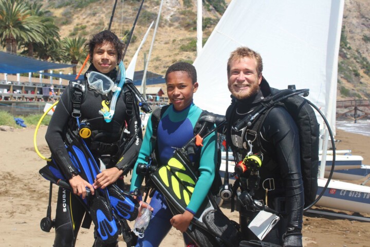 Boys smiling in scuba gear.