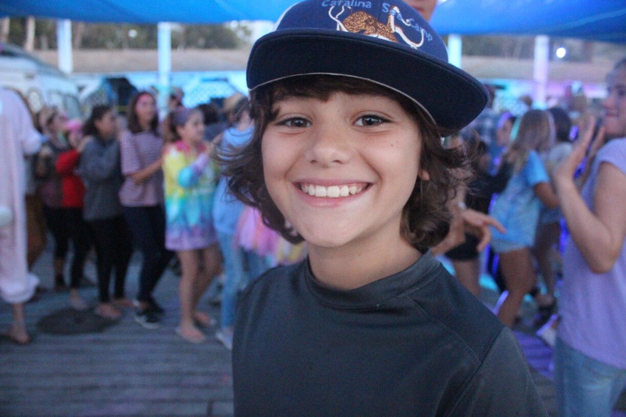 Boy in hat smiling.
