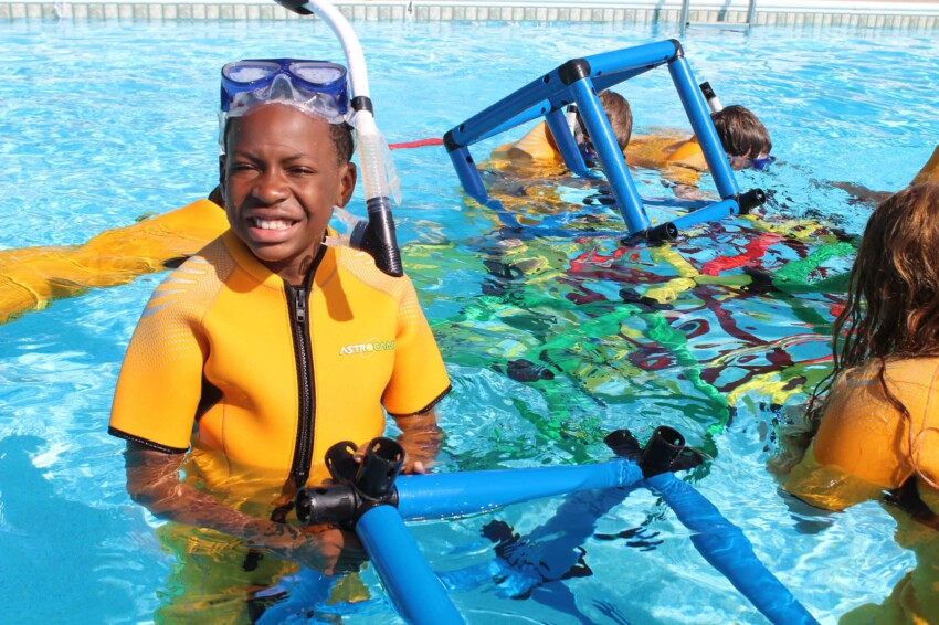 Kid smiling in snorkeling gear.