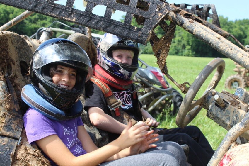 Girl and boy riding ATV.